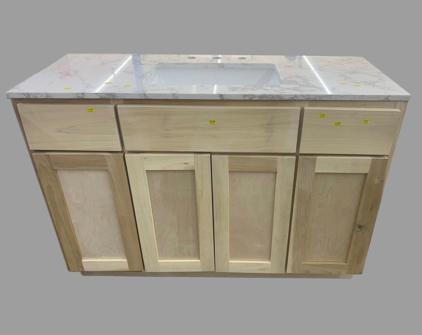 Wooden kitchen cabinet with marble countertop and sink on a gray background