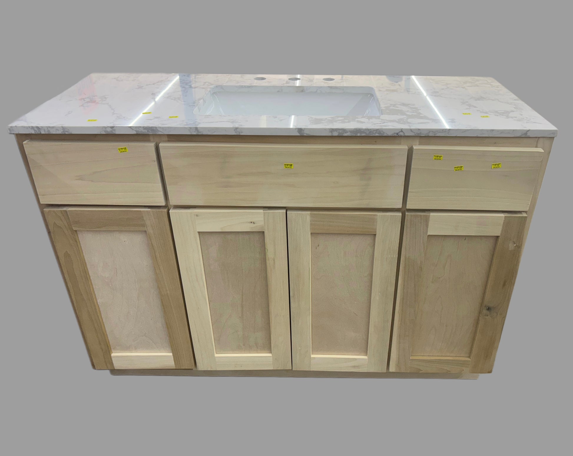 Wooden kitchen cabinet with marble countertop and sink on a gray background